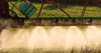 Spraying Wheat in the late Winter Sun.